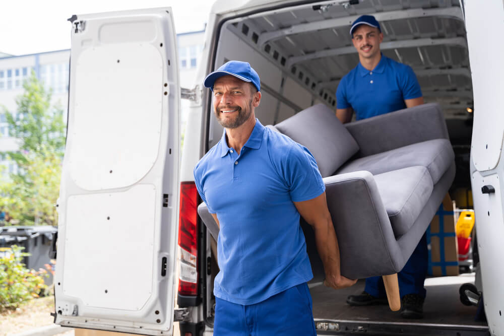 Movers Carrying Sofa During Relocation